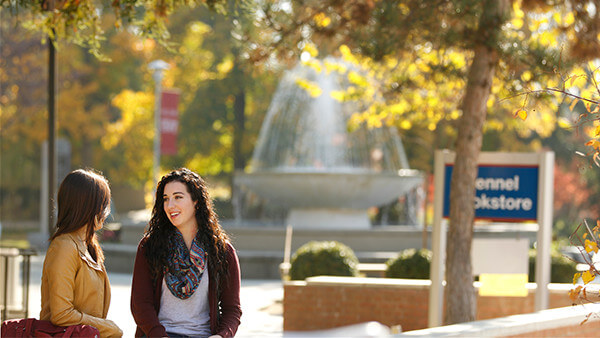 Fresno State students sitting by the fountain