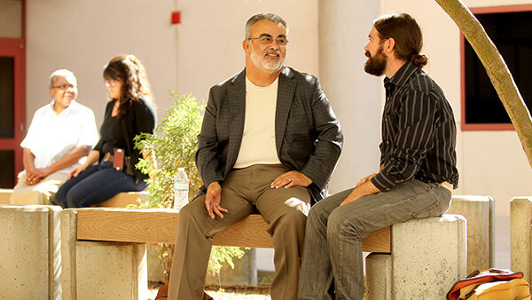 Faculty mentors talking with their protégés