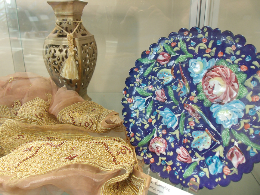 Symbols of Nowruz: "new" clothes, lamps or candles, and a traditional enameled plate