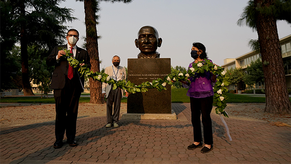 President Joseph I. Castro (left), with Dr. Sudarshan Kapoor and Dolores Huerta place a garland at the Ghandi memorial.