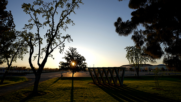 Sunset in front of the he Sweet Sixteen sculpture east of the Phebe Conley Art Building at Fresno State.
