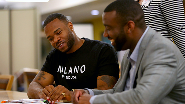 Two African American men smiling, a mentor and mentee