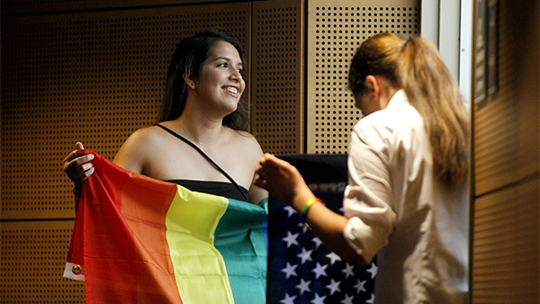 Student holds a rainbow pride flag.