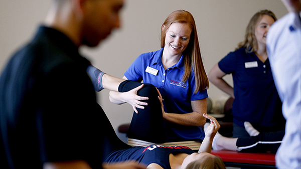 A physical therapy student works on a patient