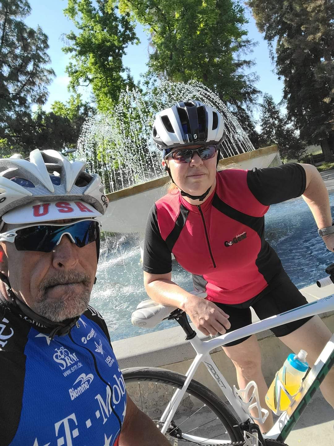 Tanisha Garcia with her husband Matthew Garcia, on bikes in front of the fountain on campus.