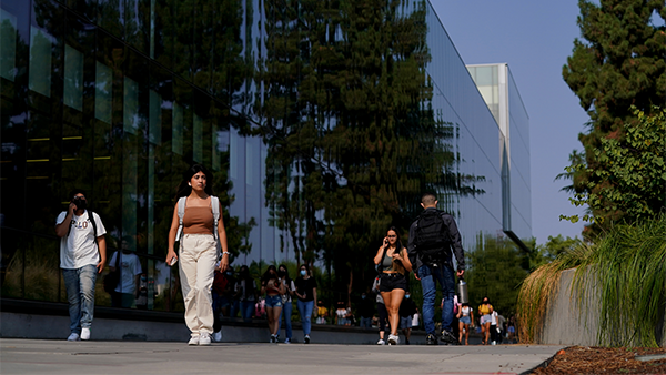 Students walking outside of the Henry Madden Library.