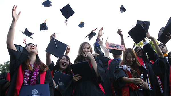 Asian students celebrate graduation.