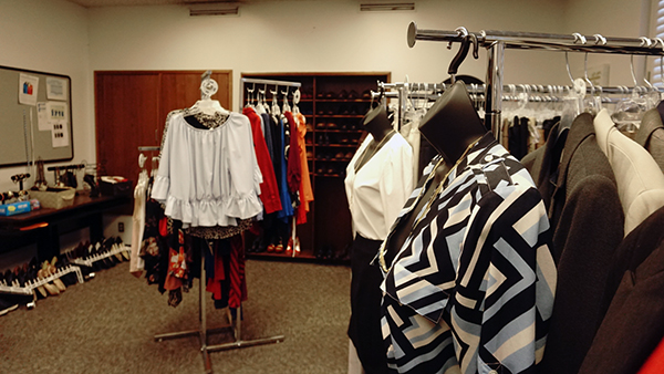 Women's clothing hangs on racks and hangers in the Clothing Closet at Fresno State.