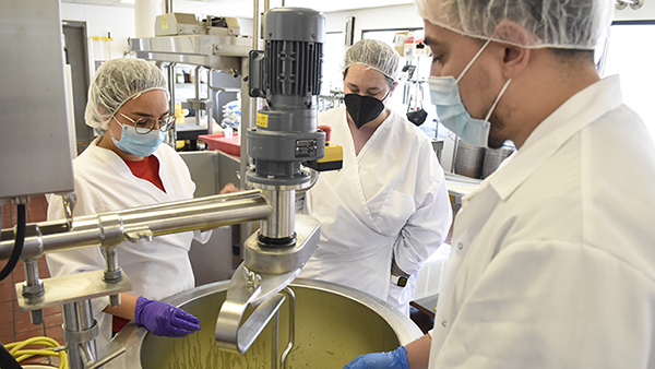 Dr. Carmen Licon works with students in the campus creamery.