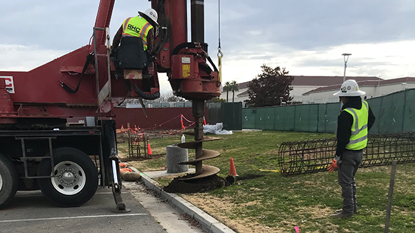 Machine digging holes