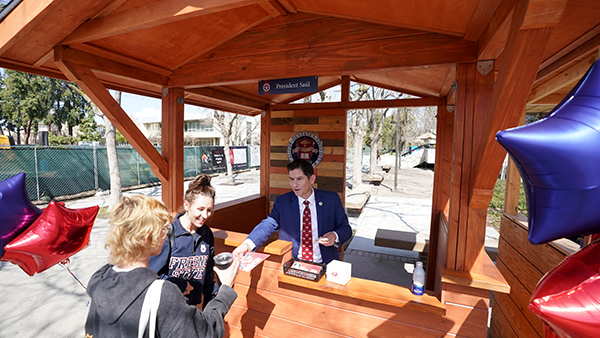 President Saúl Jiménez-Sandoval hands out stickers in his new presidential booth.