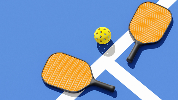 Graphic of two yellow pickleball paddles and a yellow ball on a blue background.