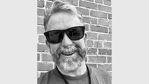 Black and white photo of David Hembree where black sunglasses.