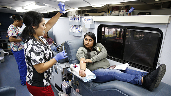 Nurse and woman in bloodmobile