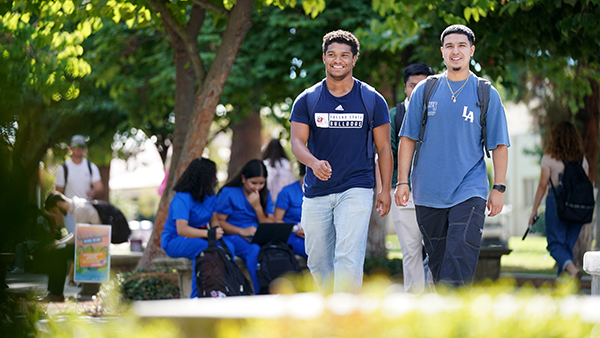 Two male students walking through the Fresno State campus.