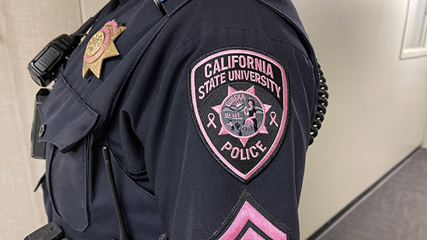 Breast Cancer Month Awareness patch on police officer's uniform.