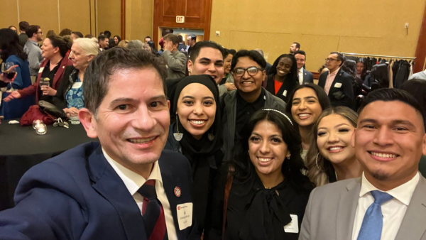 President Saúl Jiménez-Sandoval taking photo with Fresno State students