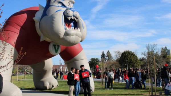 Students posing in front of Victor E. Bulldog