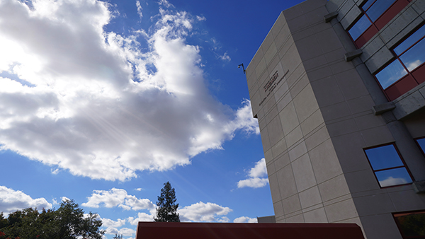 Photo of the clouds drifting over the Kremen School building.