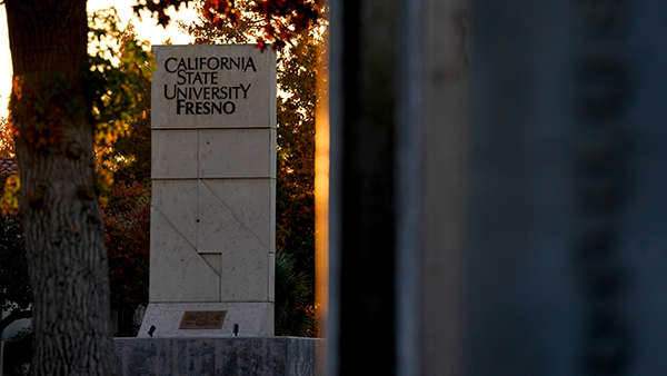 Sunset photo of California State University, Fresno monument on campus.