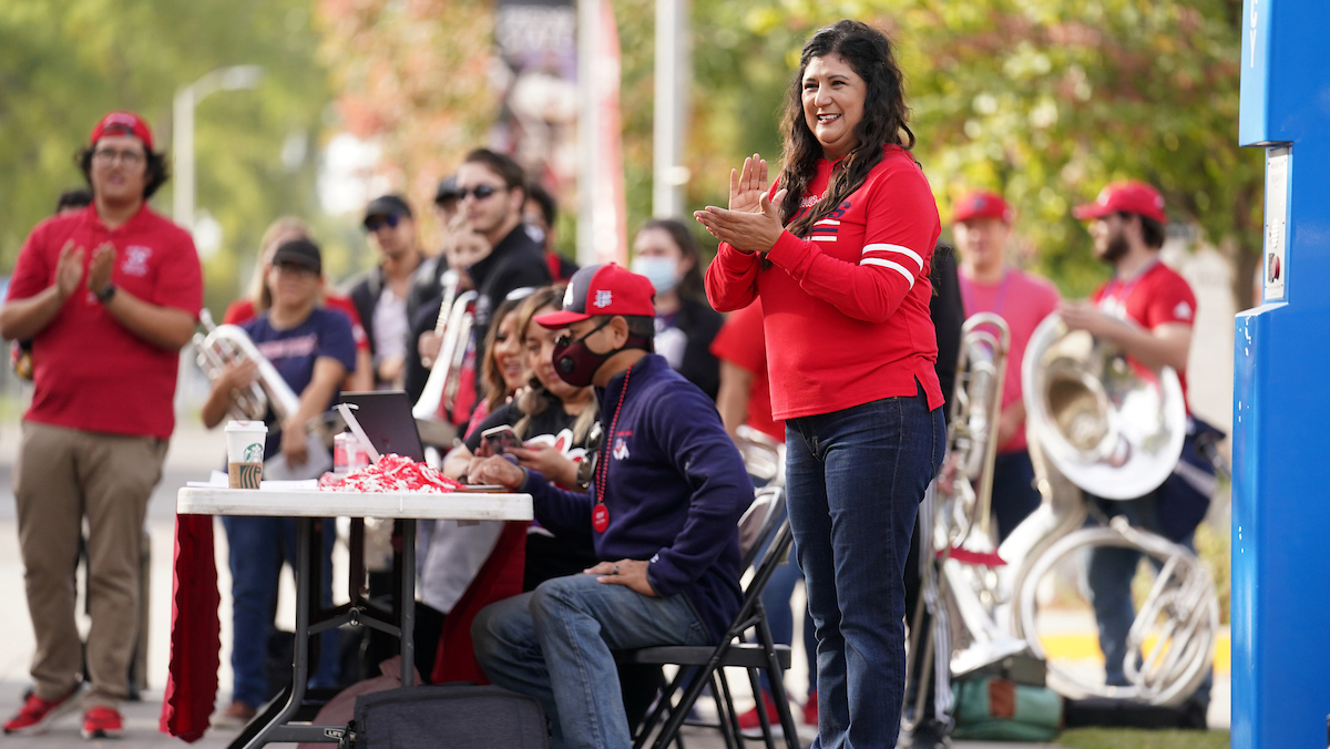 Belinda Munoz claps at a Red Friday event.