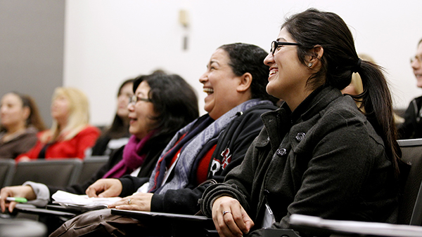 Female staff in a meeting smiling