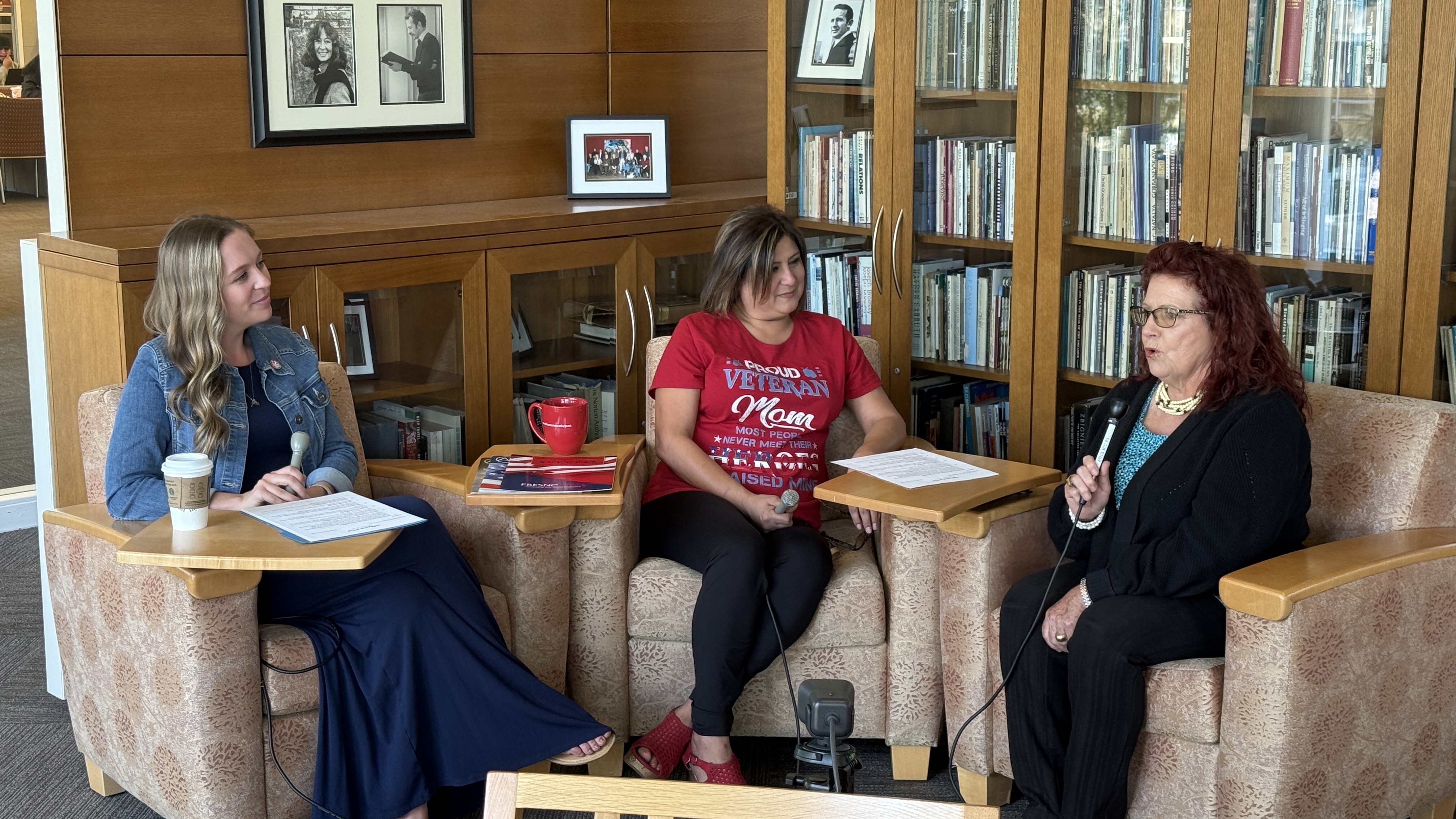 Women speaking on couches in library