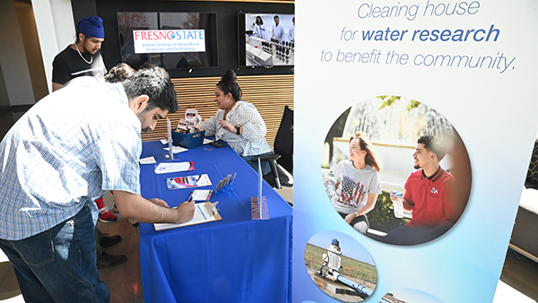 Participants signing in at the registration table for World Water Day.