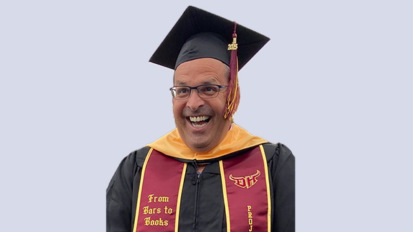 Jason A.H. Abhyankar in graduation robes and stole.