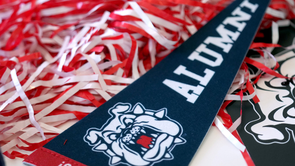 Alumni banner on pom poms