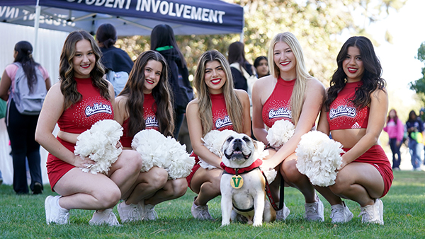 Fresno State cheerleaders posing with Victor E.