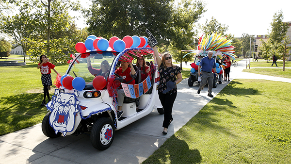 Students, faculty and staff walking in the Fresno State Pawrade for Homecoming