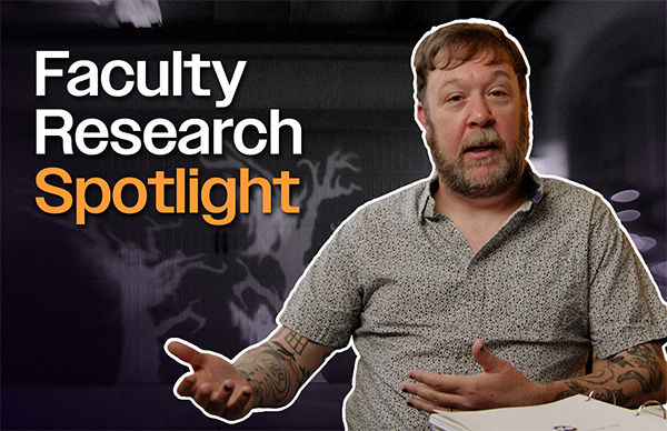 Dr. William Force gestures to the left in an interview for the Faculty Research Spotlight.