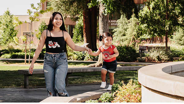 Parent Scholar and child walking around Fresno State campus