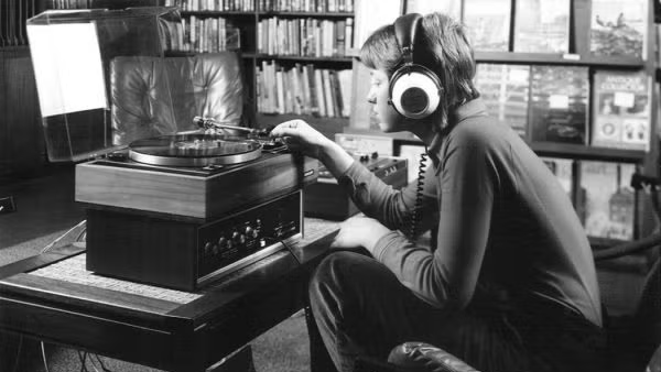 Student listening to music on record player with headphones on