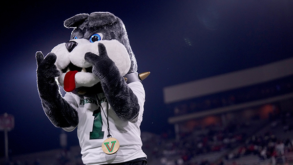 TimeOut holding two peace signs with his fingers.