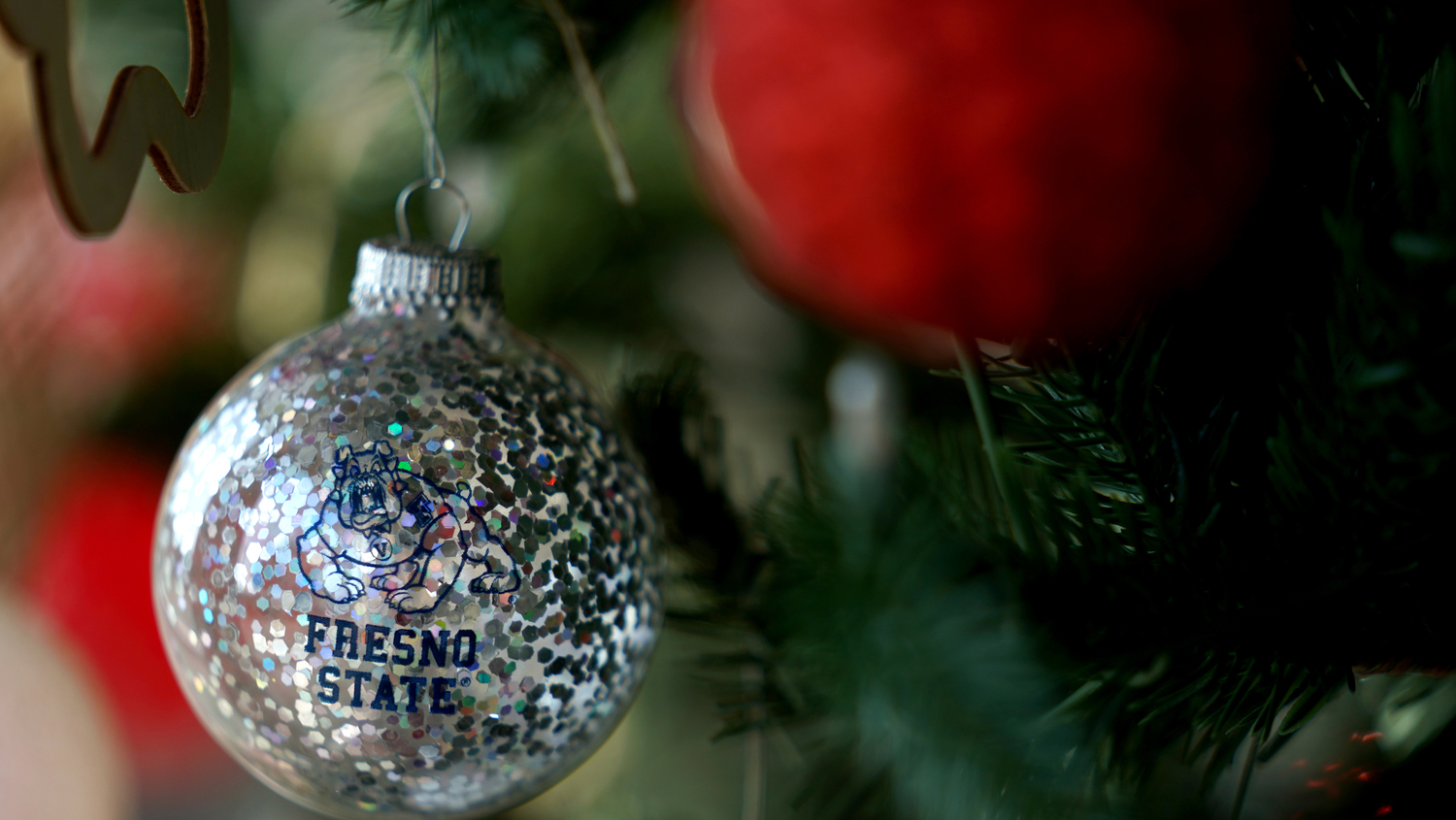 Silver glitter Fresno State holiday ornament on christmas tree