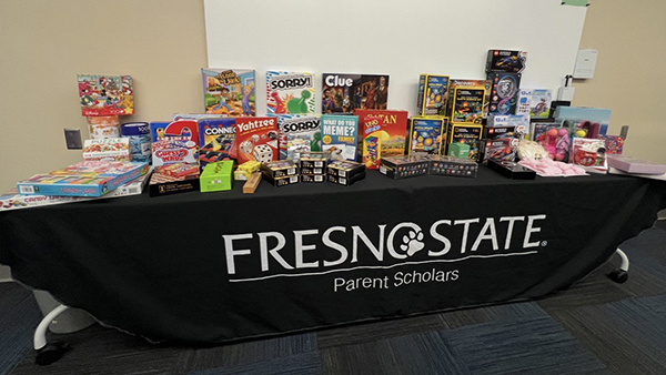 Game boxes sitting on a table for Fresno State Parent Scholars.