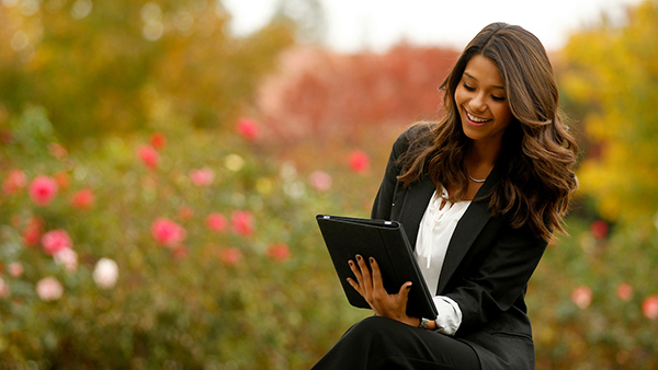 Woman sitting while looking at device