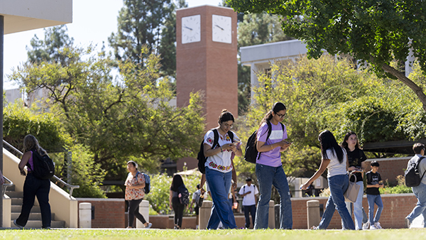 Students walking in front of the clock tower.