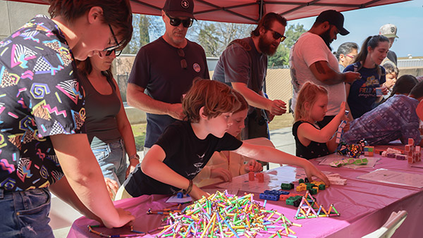 Parents and children playing with blocks on a table