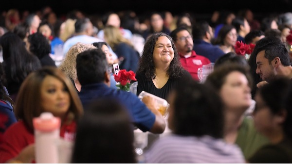 Staff and Faculty sitting down at table for STAR Day at Fresno State Savemart Center