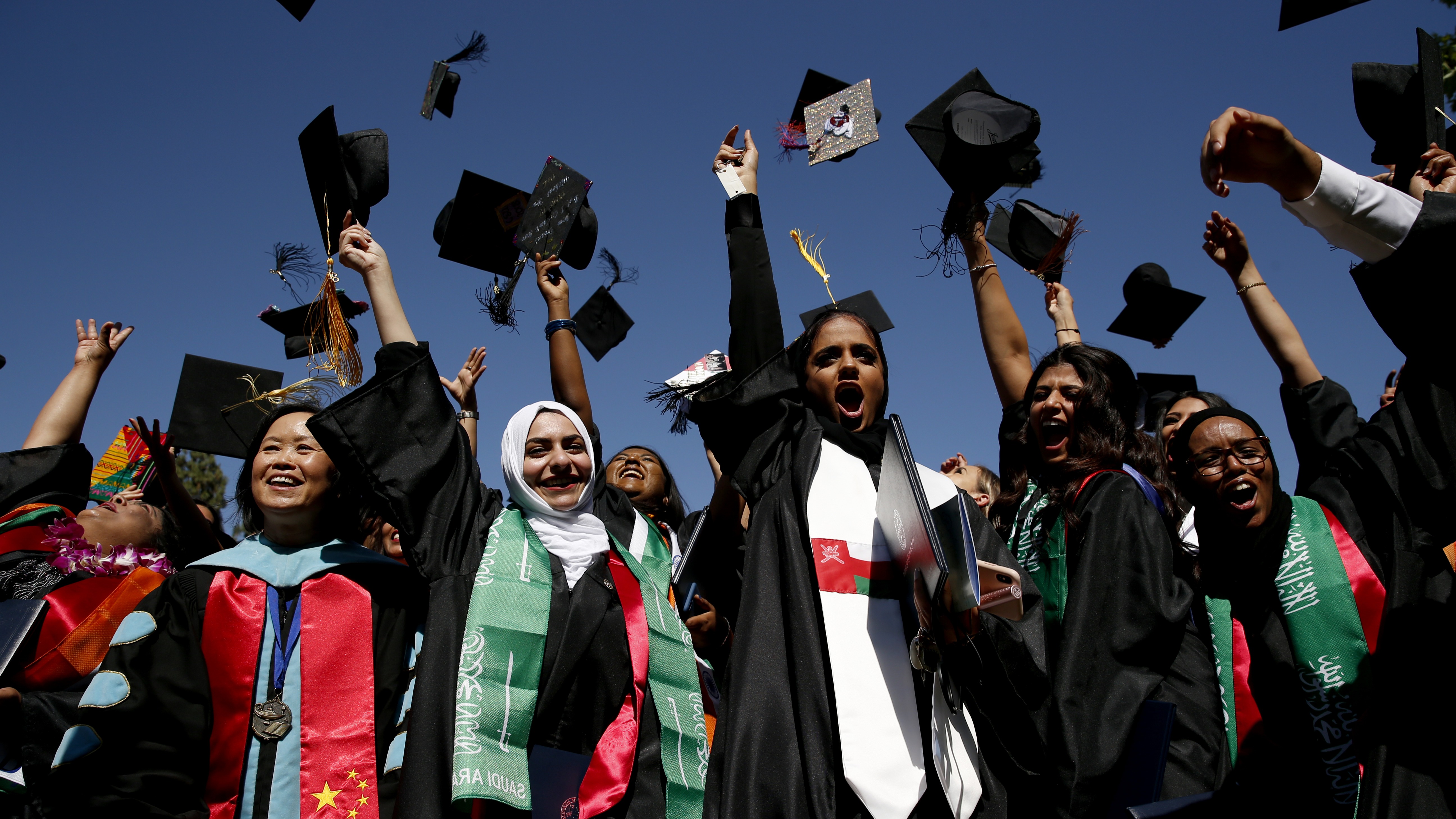 Graduate students throwing caps in the air