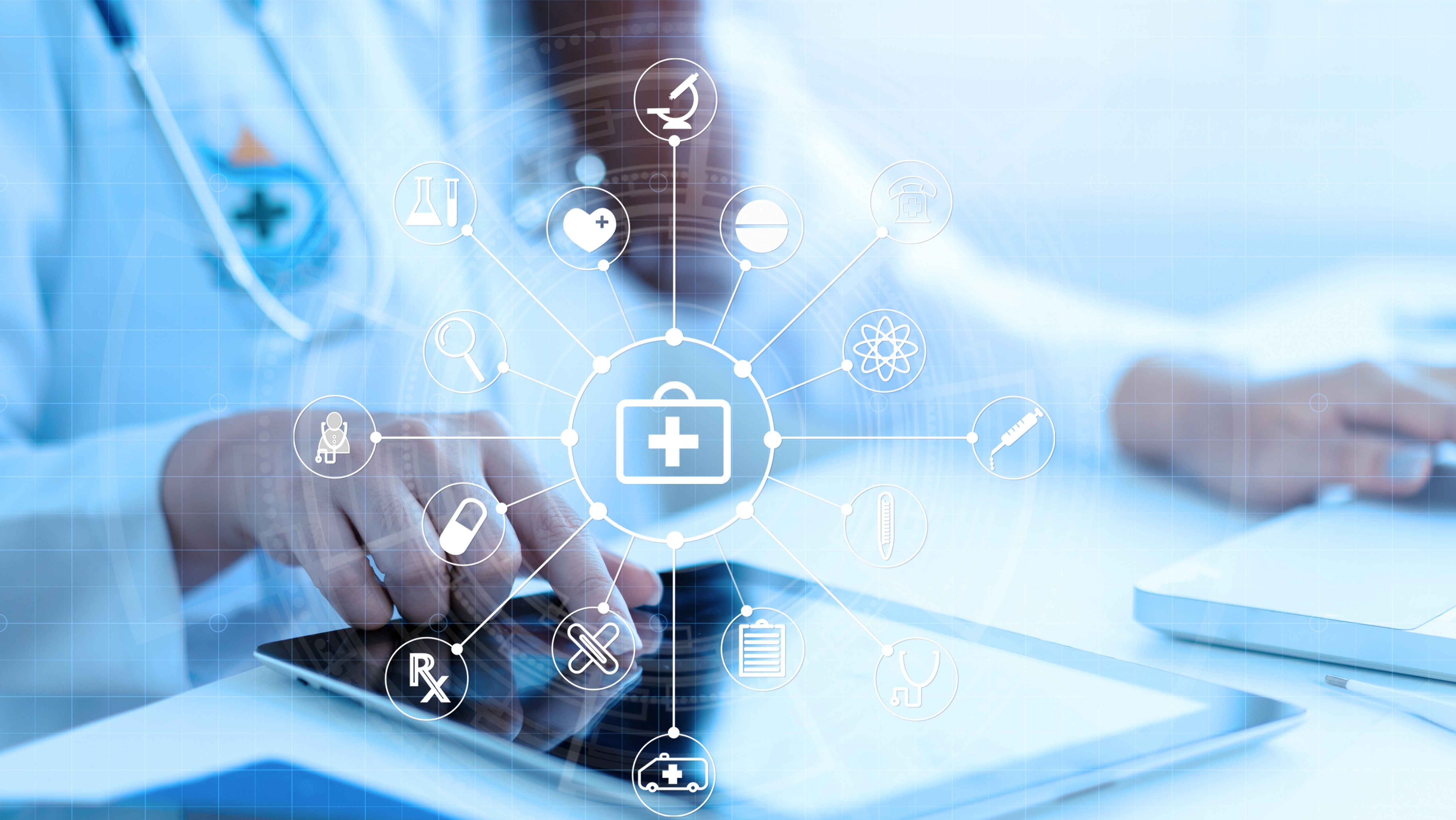 person in white lab coat touching tablet screen with medical symbols on screen