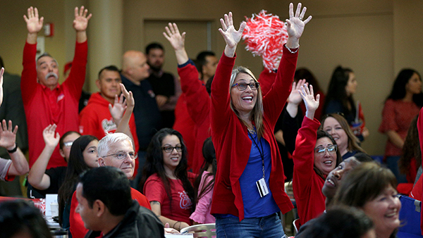 Fresno State Faculty and Staff waving their hands in the air