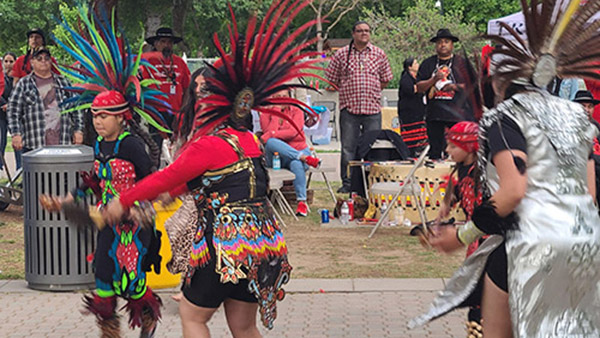 Native American students performing indigenous dance in Fresno State quad
