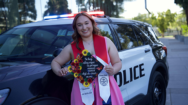Stephanie Cota, Police Dispatcher, Police Department in front of police car