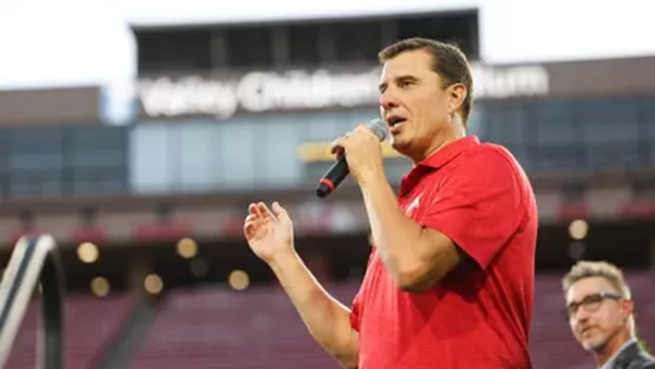 Paul Loeffler, the "Voice of the Bulldogs," at the microphone at Valley Children's Stadium