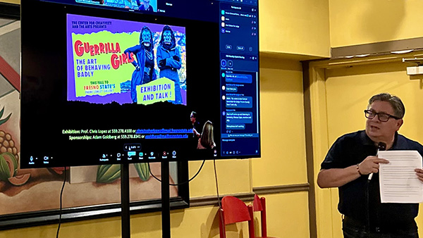 Dr. Peter Robertson giving a presentation about Guerrilla Girls