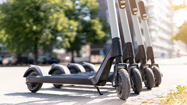 Shot of the bottom of four scooters standing next to each other.